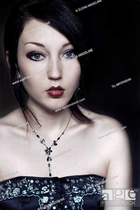 Portrait Of A Young Woman With Black Hair Blue Eyes And Pale Skin