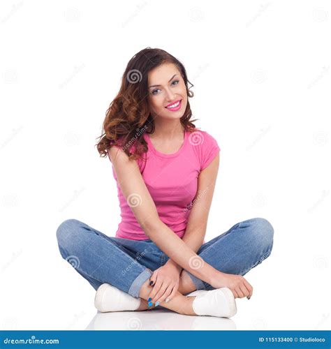 Beautiful Young Woman Is Sitting On Floor With Legs Crossed Smiling