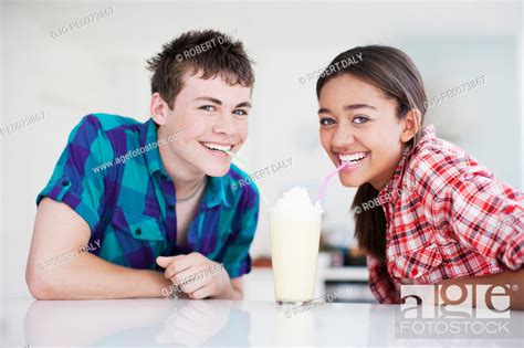 Teenage Couple Sharing Milkshake Stock Photo Picture And Royalty Free