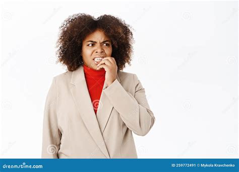 Anxious Female Office Worker Businesswoman Bites Finger And Looks