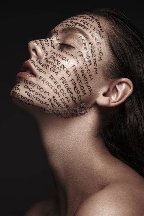 Portrait Of Beautiful Girl With Painted Words On Her Face Art Make Up