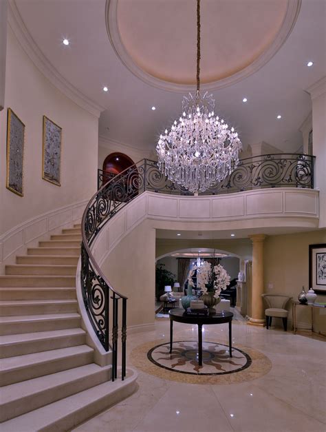 Grand Entrance With Curved Stairway And Chandelier Luxury Staircase