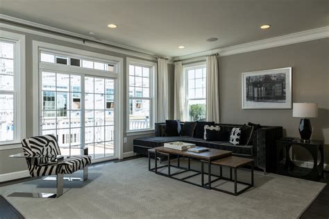A Living Room With Zebra Print Furniture And Large Windows In The Back