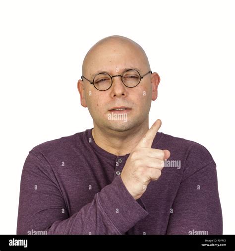 Studio Portrait Of Bald Man With Round Glasses Gesturing In A
