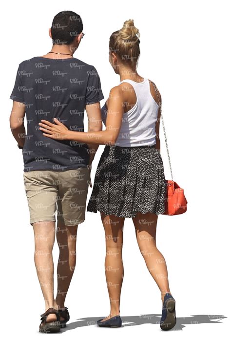 A Man And Woman Walking Down The Street With Their Hands On Each Other
