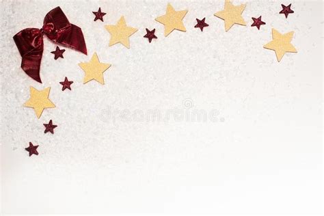 Christmas Background With Gold Glitter Stars Red Bow And Snow Stock