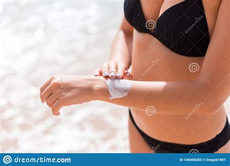 Pretty Girl Is Putting Sun Lotion On Her Hand At The Beach Stock Image Image Of Burn Female