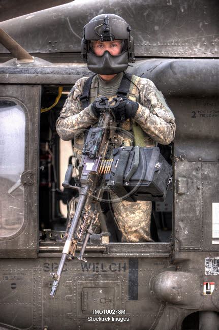 A Uh 60 Black Hawk Door Gunner Manning A M240g Medium Machine Gun