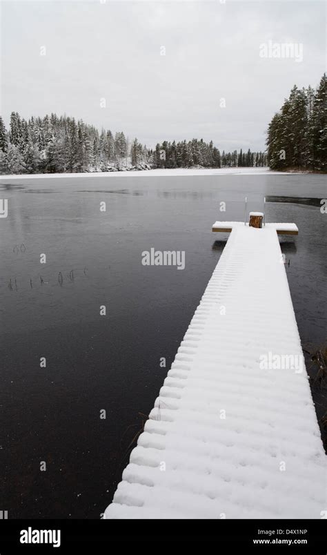 Snowy Pier At Freezing Lake Finland Stock Photo Alamy