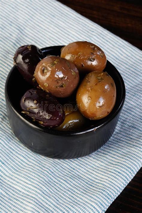 Black And Green Olives In Wooden Plate On Wooden Background Salted