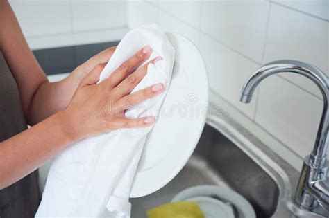 Cropped Image Of Attractive Young Woman Is Washing Dishes While Doing