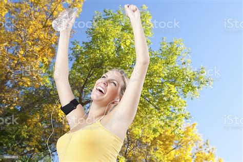 Smiling Female Runner With Arms Raised Stock Photo Download Image Now