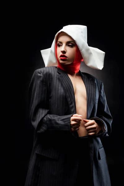 Attractive Nude Sexy Nun Posing In Black Suit And Red Scarf Isolated On Black Fashion Shoot