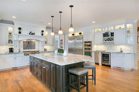 A Large Kitchen With White Cabinets And An Island In The Middle Of The