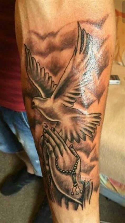 Men place this black or grey guardian angel tattoo on their upper or forearm. Praying hands | Tattoos, Lower arm tattoos