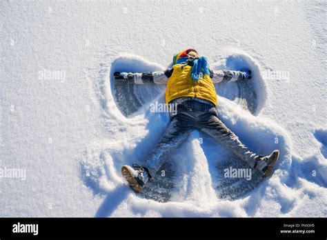Boy Making A Snow Angel Stock Photo Alamy