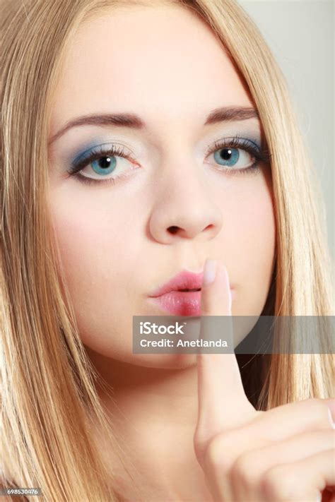 Woman Asking For Silence Finger On Lips Stock Photo Download Image
