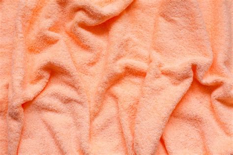Premium Photo Soft Peach Fabric With Waves And Folds Soft Pastel