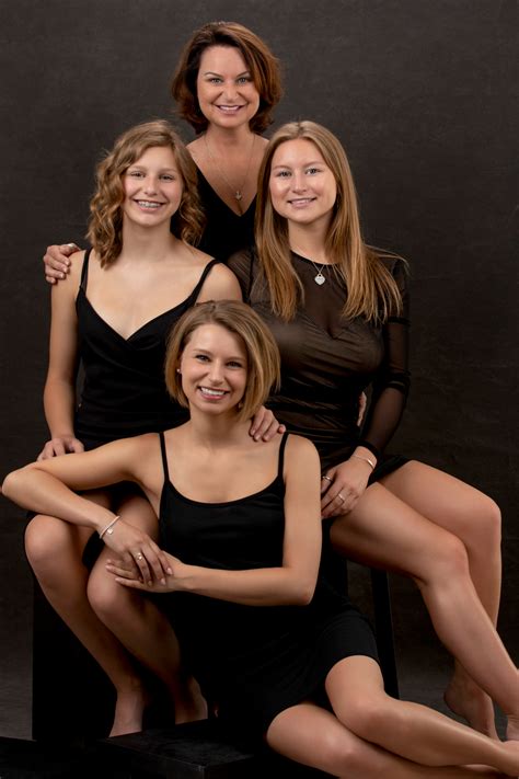 Three Women In Black Dresses Posing For A Photo With Their Arms Around One Woman S Shoulders