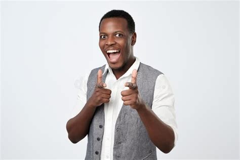 Young Handsome African Man With Two Hands Guns Sign Gesture Pointing At