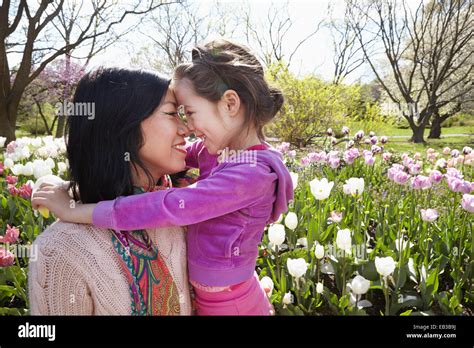 Mother And Daughter Rubbing Noses In Park Stock Photo Alamy