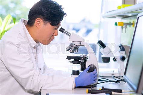 Asian Medical Doctor Working In Research Lab Science Assistant Making