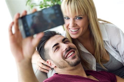 free photo a couple doing selfie on sofa