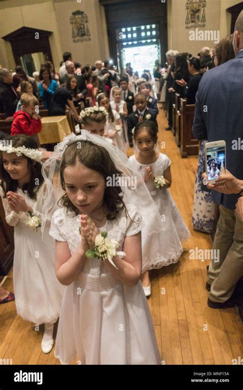 First Holy Communion Ceremony For Children At A Catholic Church In