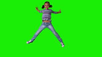 Happy Girl Jumping Up And Down On A Green Screen In Slow Motion Stock