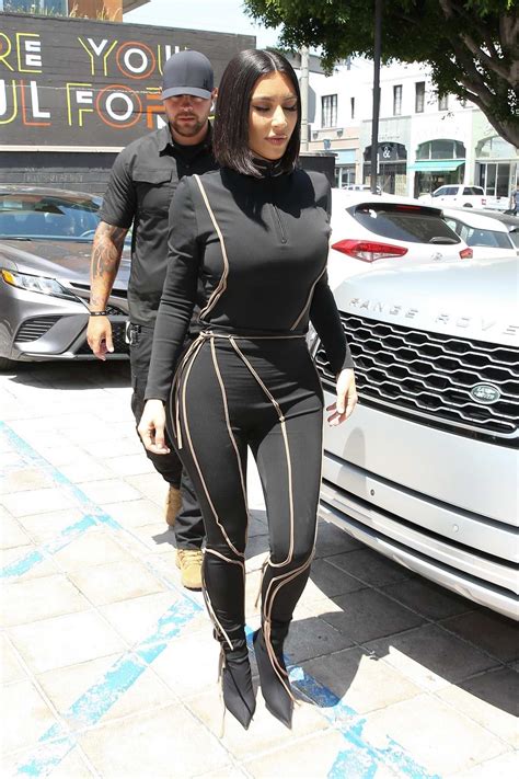 Kim Kardashian Dons Black Form Fitting Jumpsuit While Out To Lunch At Cafe Gratitude In Los