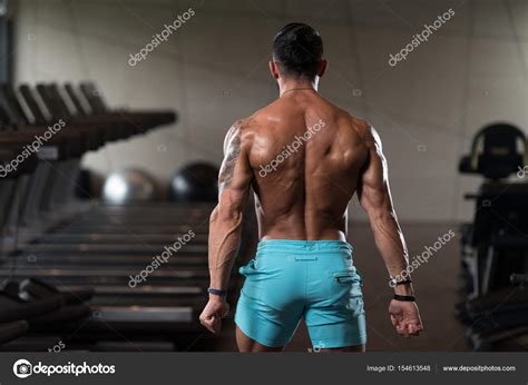 Muscular Man Flexing Back Muscles Pose Stock Photo By ©ibrak 154613548