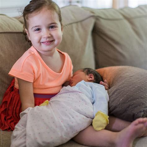 Proud Sister Holding Her Newborn Brother For The First Time By Stocksy Contributor Jakob