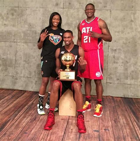 Three Basketball Players Pose For A Photo With Their Trophy