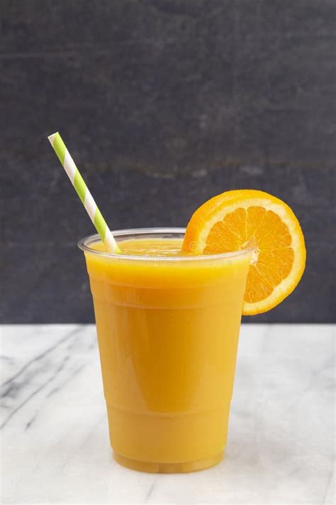 Freshly Squeezed Orange Juice In A Plastic Disposable Cup Stock Photo