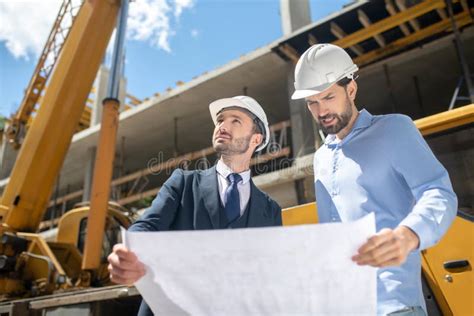 Building Supervisor And Foreman Standing On The Construction Site