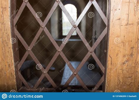 Ancient Prison Cell View Through A Window With An Iron Grid Stock