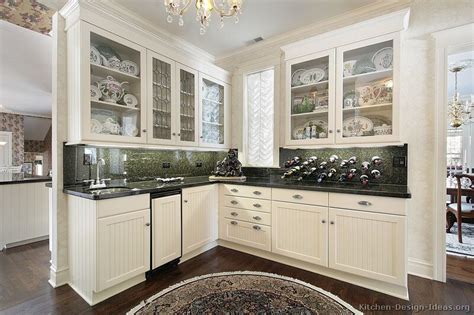 Warm white cabinets combines with superior grays and tans in the granite countertops, subway tile backsplash and porcelain tile floors. Pictures of Kitchens - Traditional - White Kitchen ...