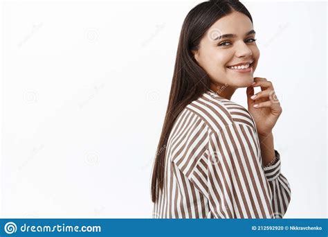 Portrait Of Stylish Modern Brunette Girl Turn Behind Shoulder At Camera And Smiling Touching