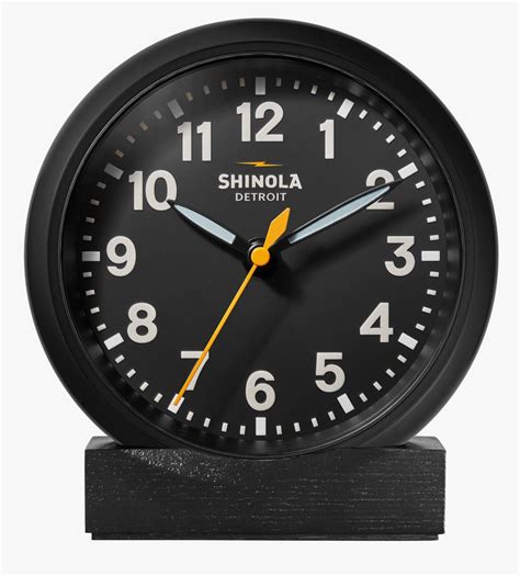 Clock hanging on wall ticking showing twelve hours. Shinola's introduces a desk version of its Runwell Wall ...