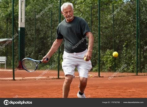 Senior Tennis Player Playing Tennis — Stock Photo © Microgen 178792786
