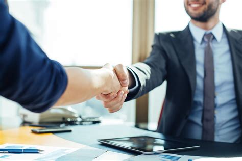 Close up of business handshake in the office - ROLINC Staffing