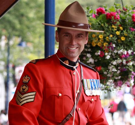 an rcmp royal canadian mounted police officer poses at whistler village british columbia