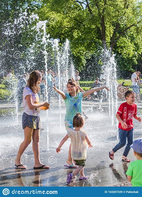 Children Playing In A Water Fountain Editorial Stock Image