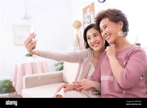 Happy Mother And Daughter To Use Mobile Phones Stock Photo Alamy