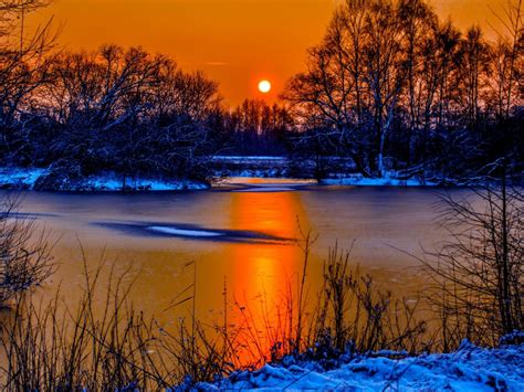 Sunset In Winter Snow River Coast Two Sun Orange Sky