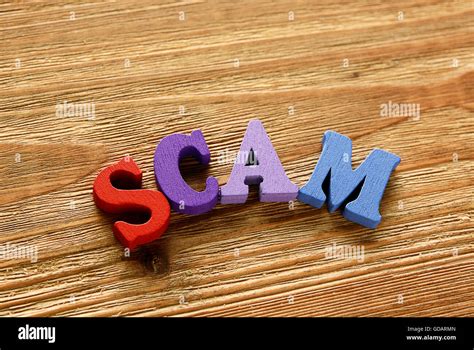 Scam Words Made From Multicolored Letters On Wooden Background Stock