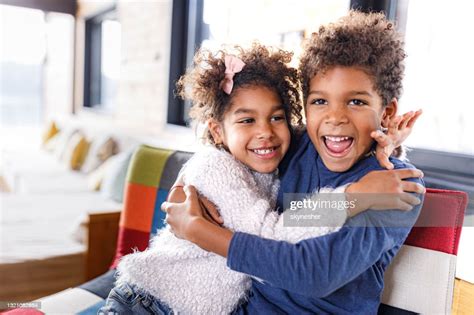 Embraced African American Siblings Enjoying At Home High Res Stock