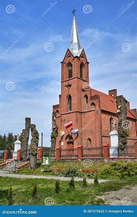 The Historic Gothic Red Brick Church With Belfry In The Village Of