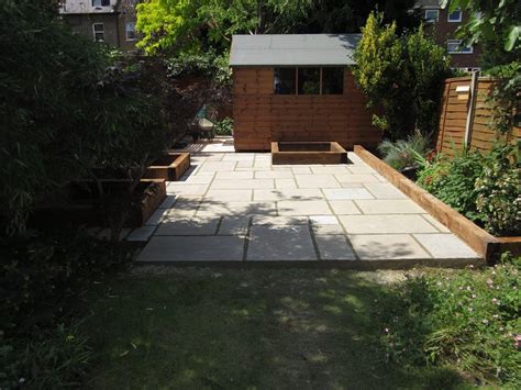 Indian Sandstone Garden Patio With Railway Sleeper Edging For Flower