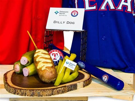 A Baseball Uniform And Some Food On A Wooden Plate With A Bat Next To It